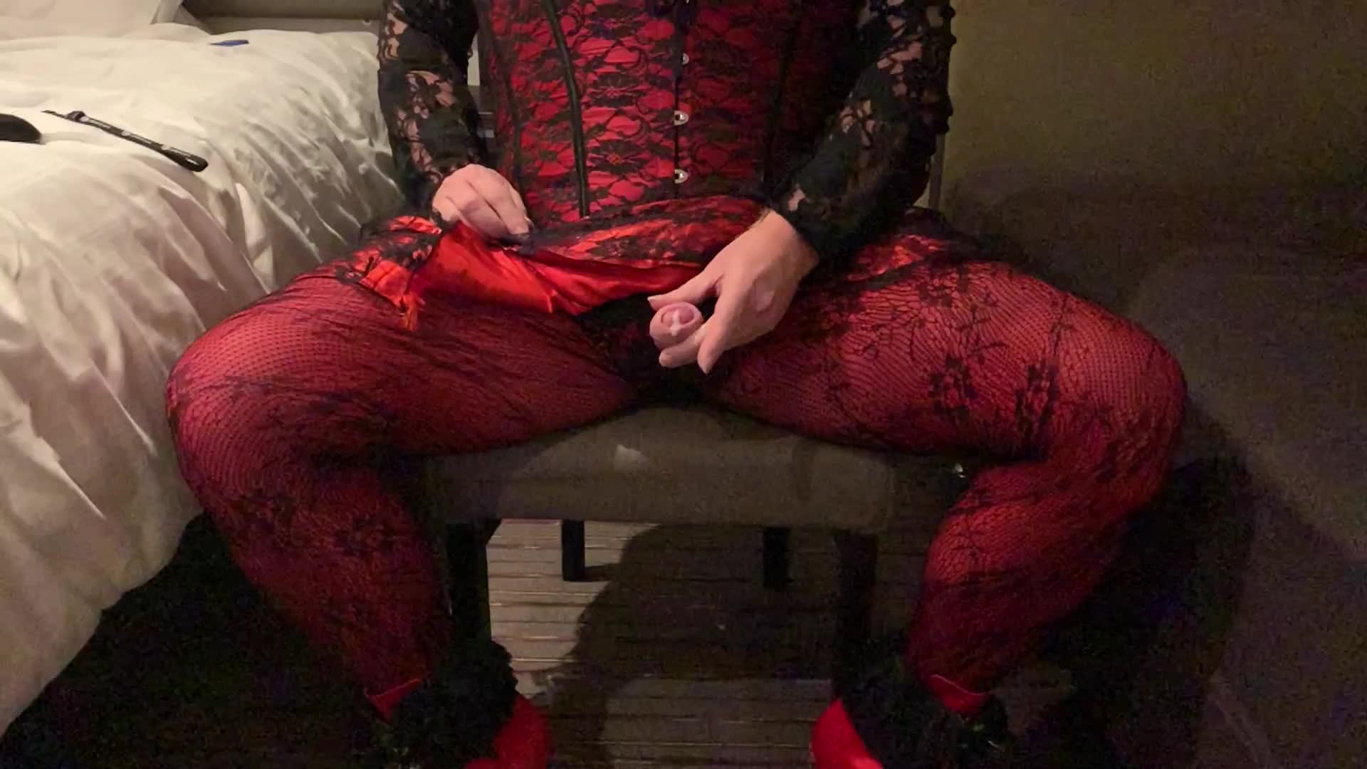 Crossdresser cums in red and black outfit